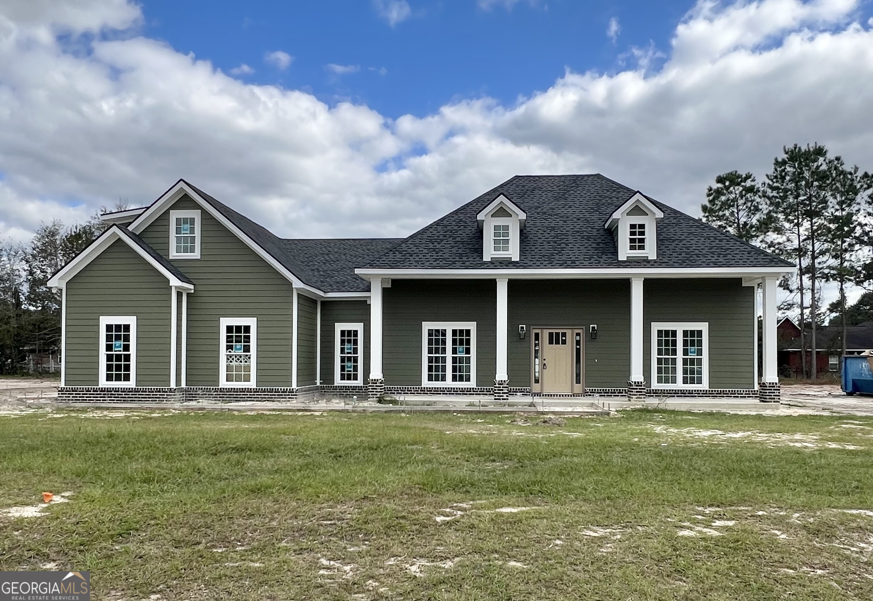 a front view of a house with garden