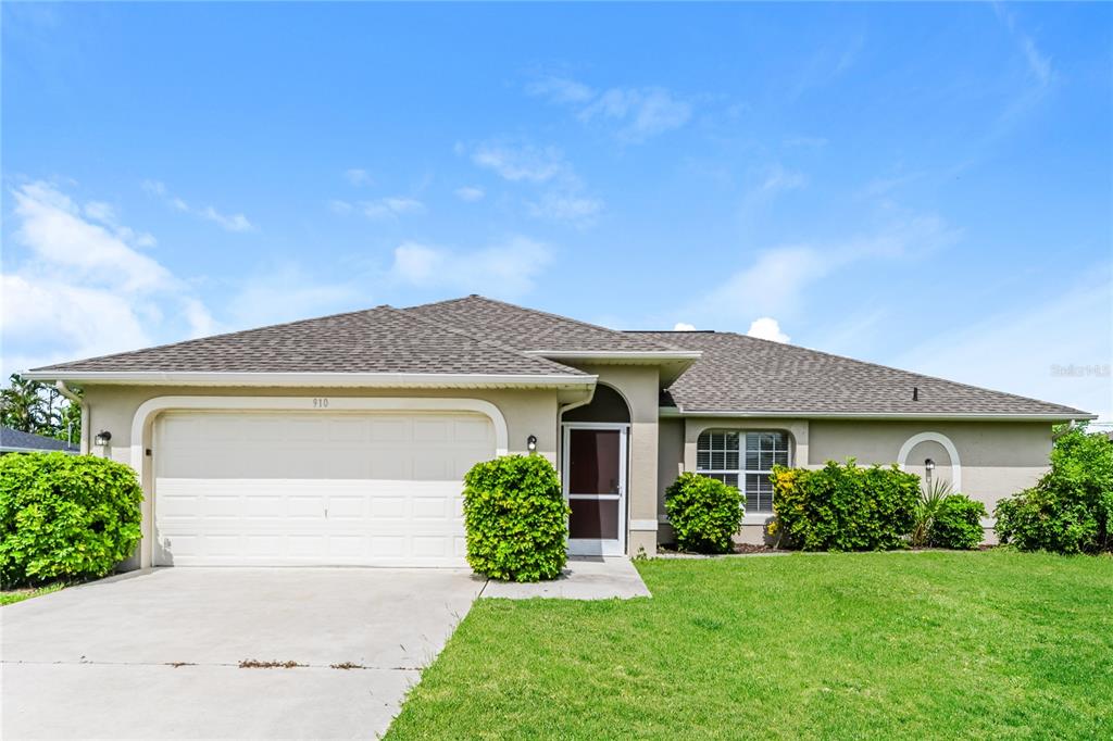 a front view of a house with a yard and garage