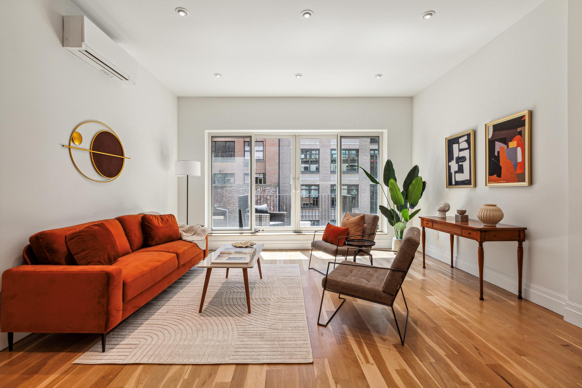 a living room with furniture and wooden floor