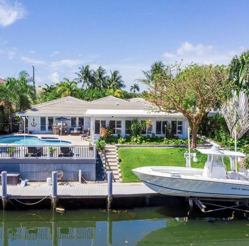 a view of house with backyard space and lake view