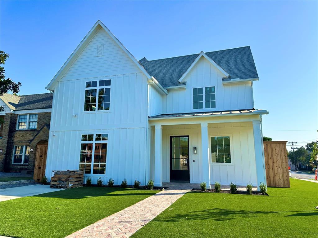 a front view of a house with a yard and porch