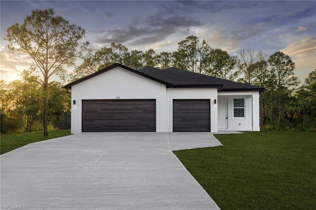 a front view of a house with a yard and garage