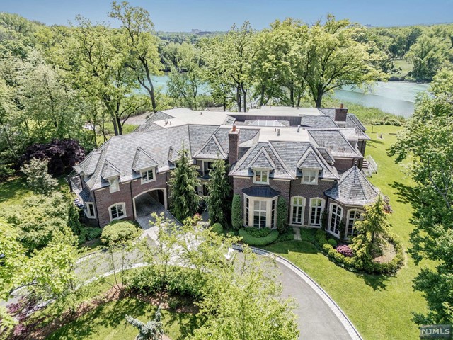 an aerial view of a house with garden space and a patio