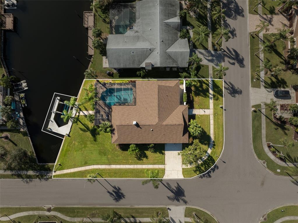 an aerial view of a house with garden space and street view