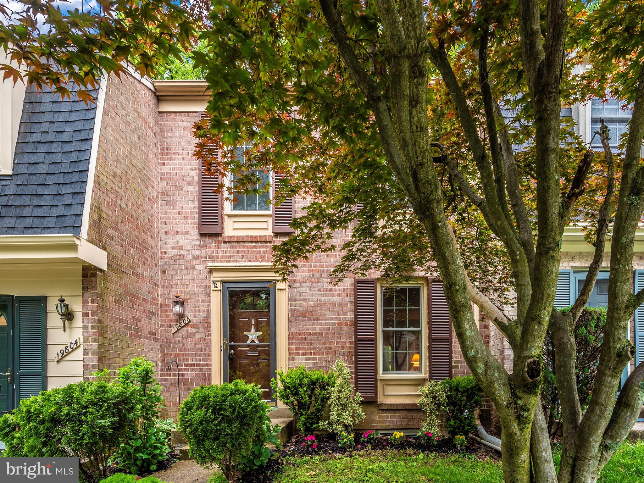 front view of a house with a tree