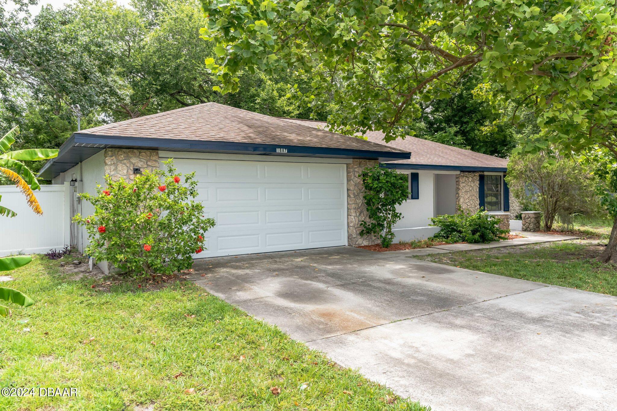 a front view of a house with garden