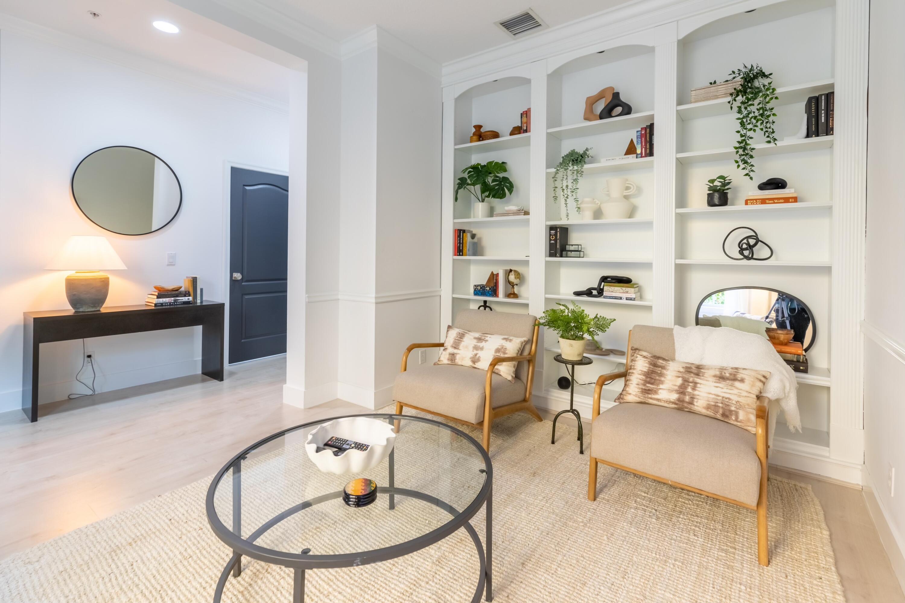 a living room with furniture and a mirror