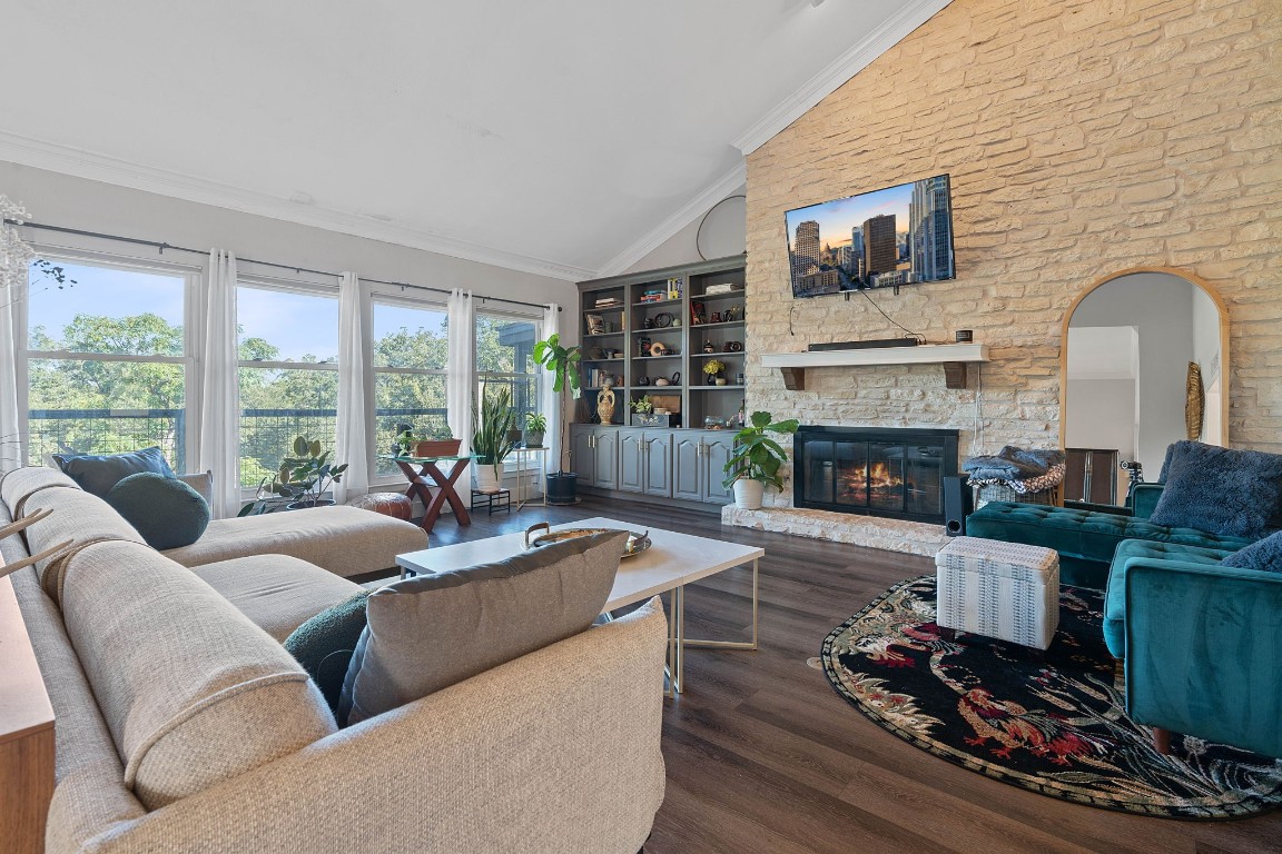 a living room with furniture fireplace and flat screen tv