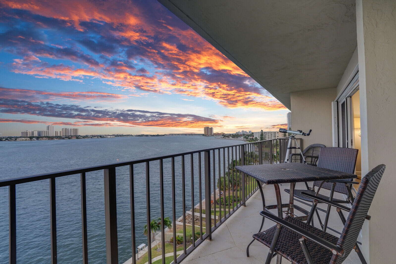 a view of a balcony with furniture and a yard