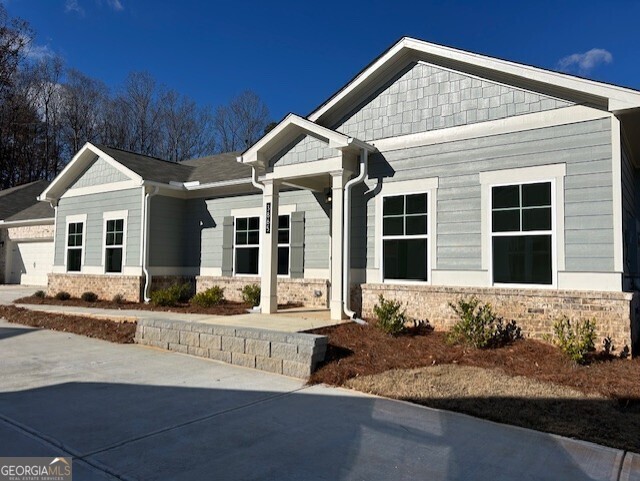 a front view of a house with sitting area