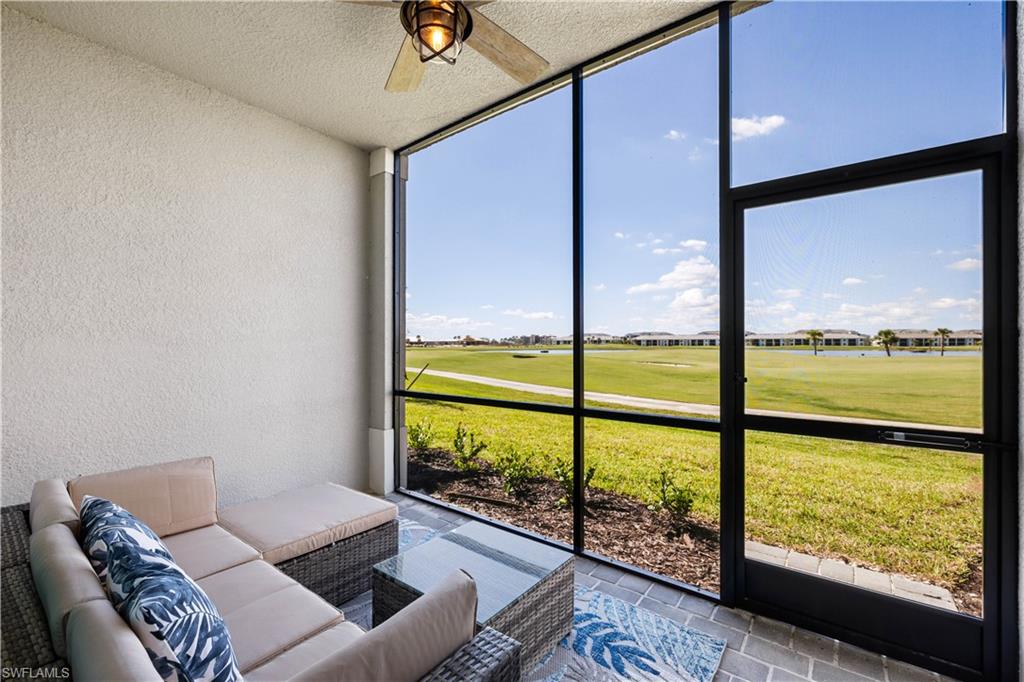 a living room with pool table and floor to ceiling windows