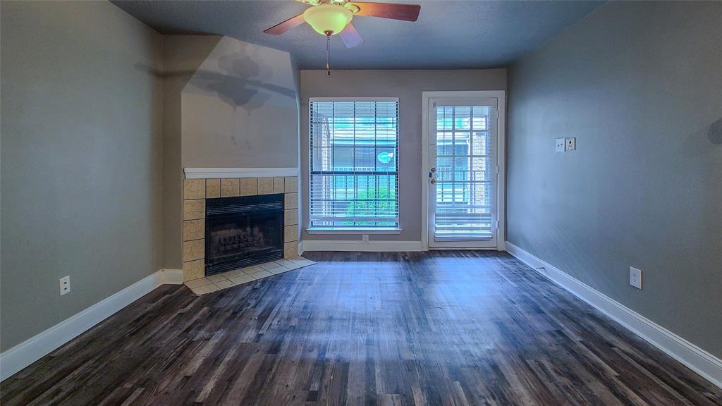 wooden floor fireplace and natural light in room