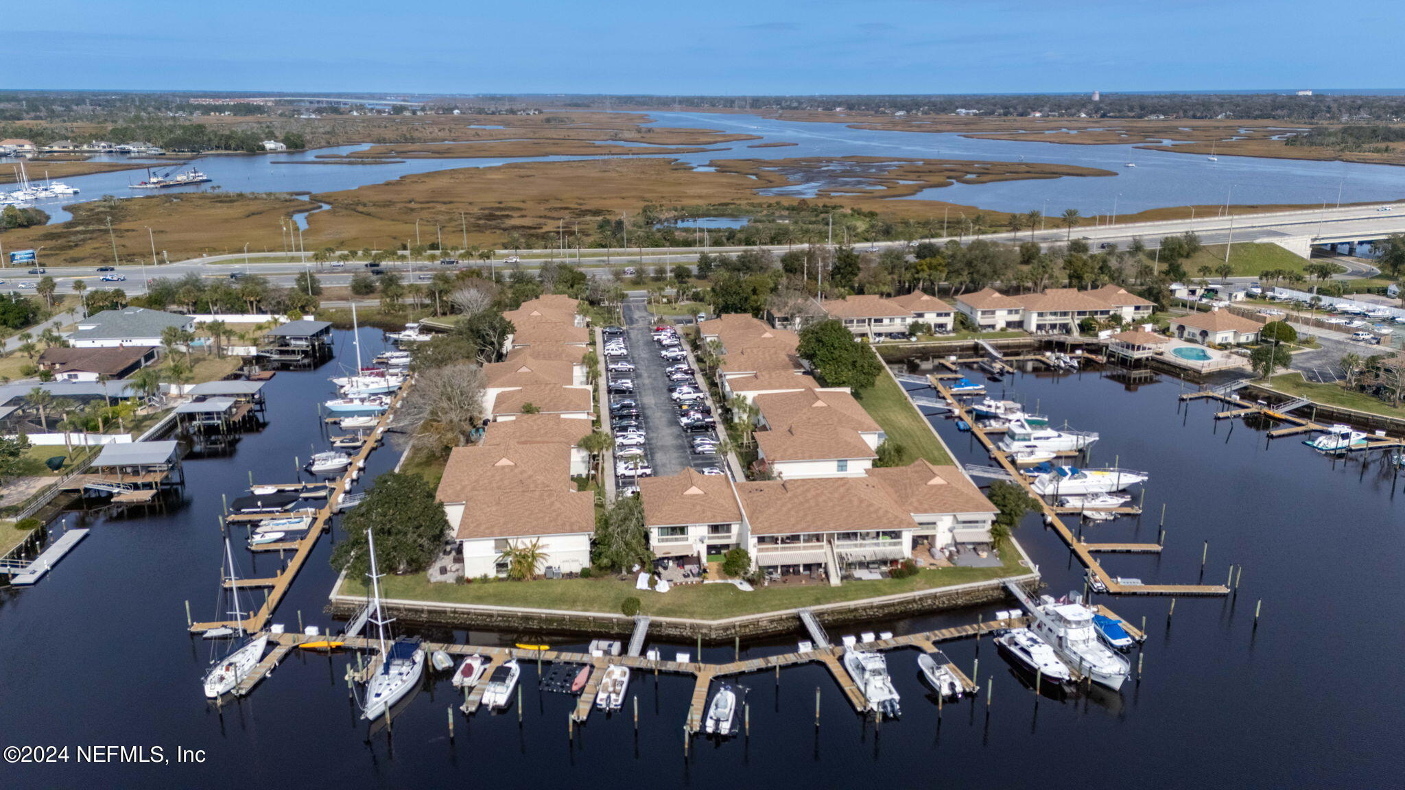 an aerial view of residential building with outdoor space and ocean view