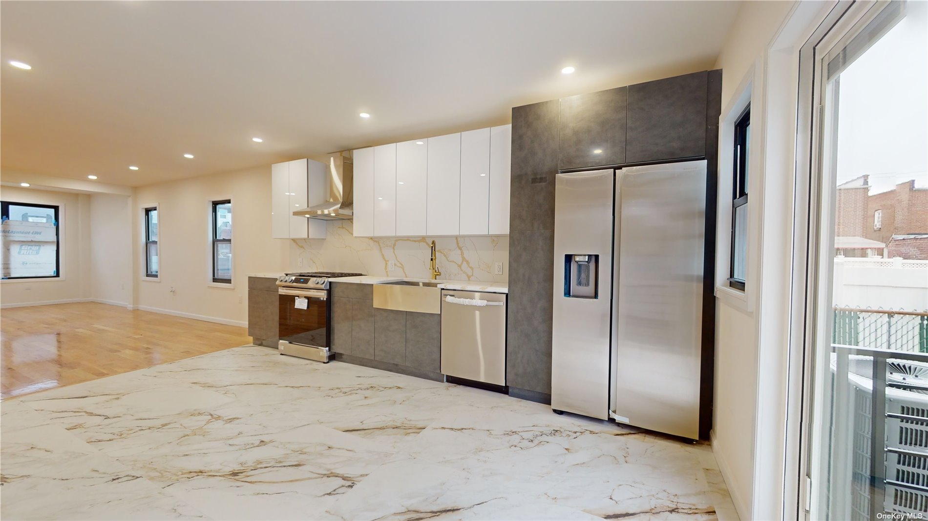 a kitchen with stainless steel appliances granite countertop a refrigerator and a sink