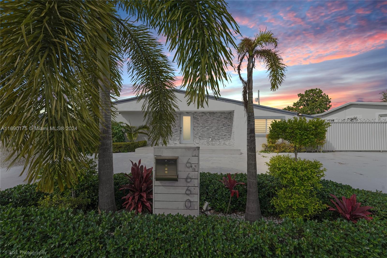 a view of house with palm trees