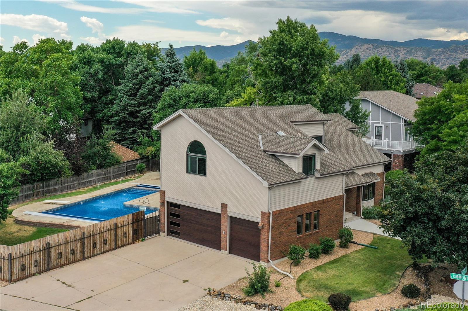 a aerial view of a house with a yard and large trees