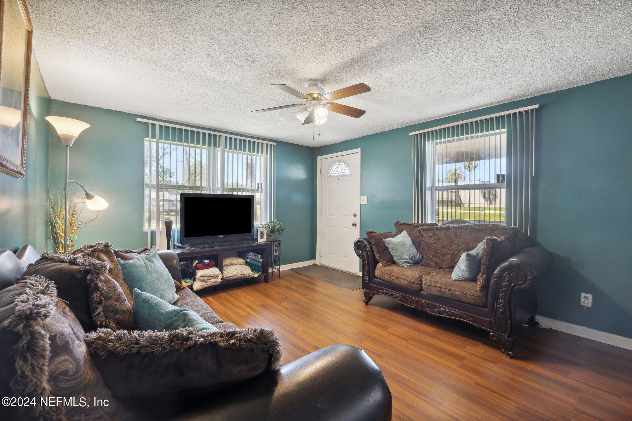 a living room with furniture and a flat screen tv