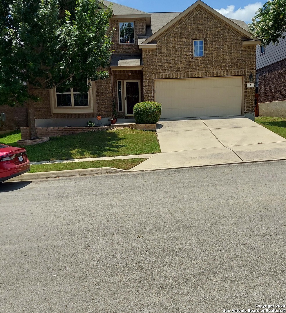 a front view of a house with a yard and garage