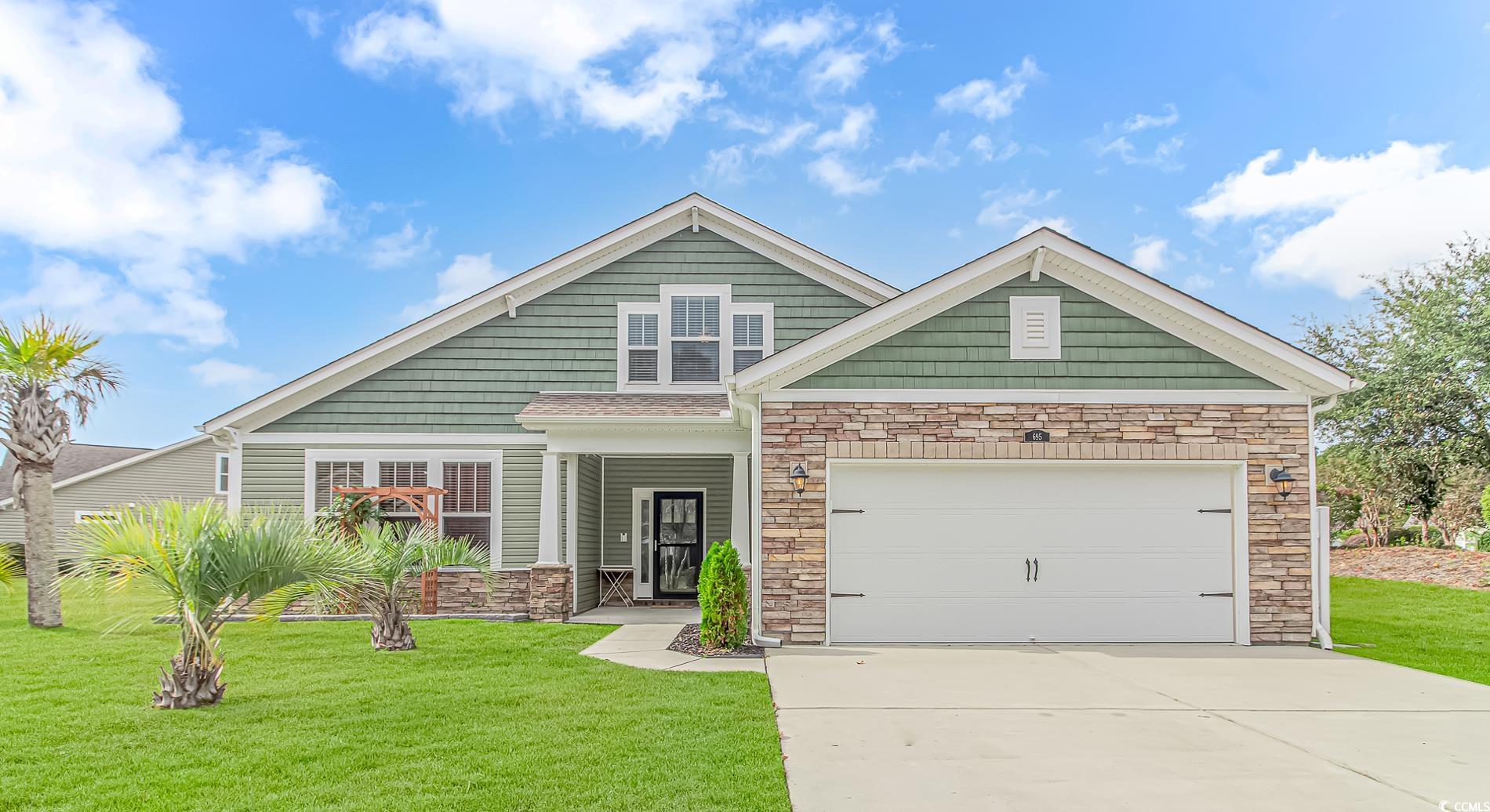 Craftsman inspired home featuring a garage and a f