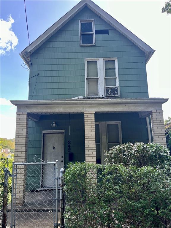 a brick house with large windows and a yard