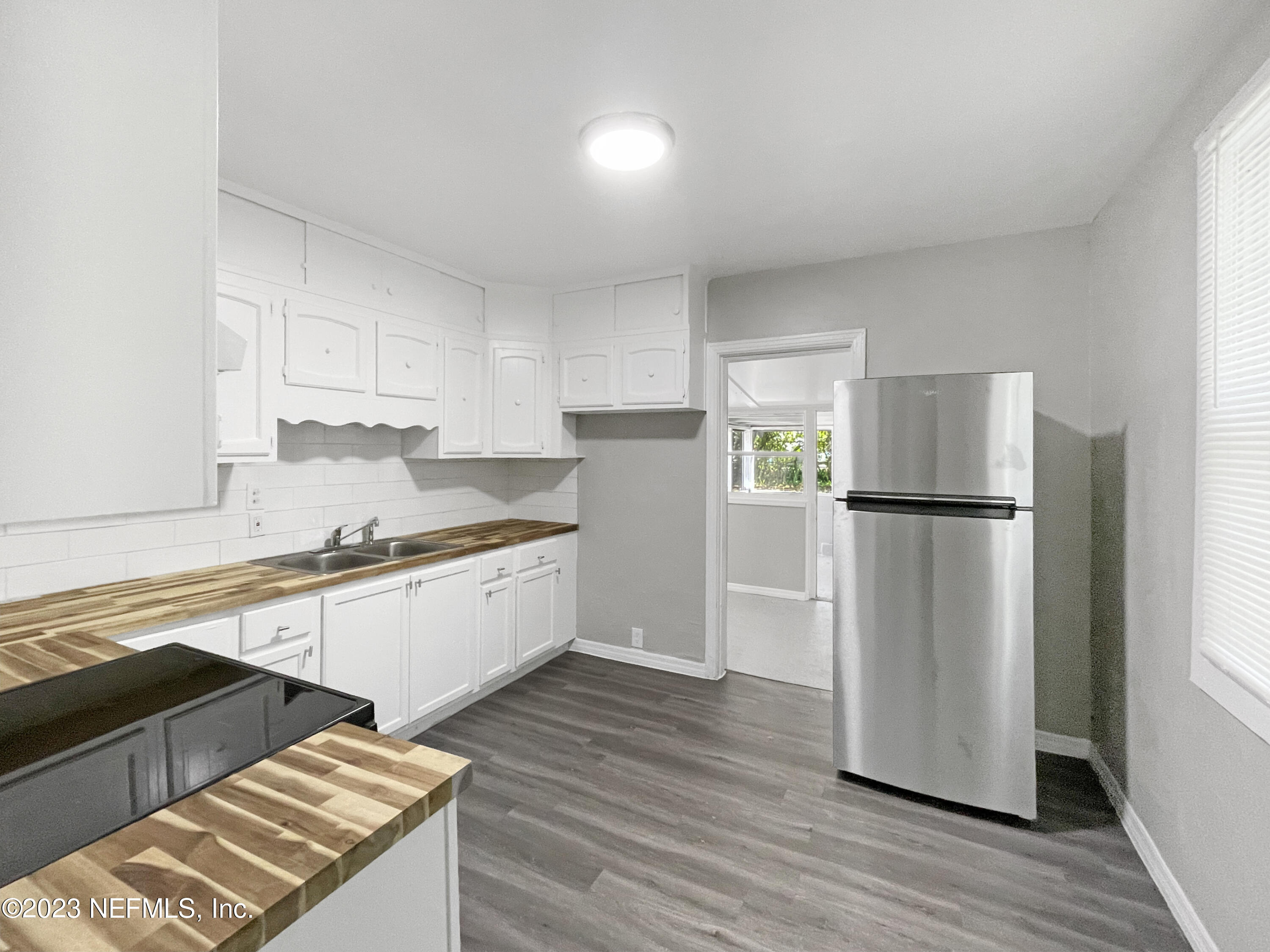 a kitchen with a refrigerator and a sink