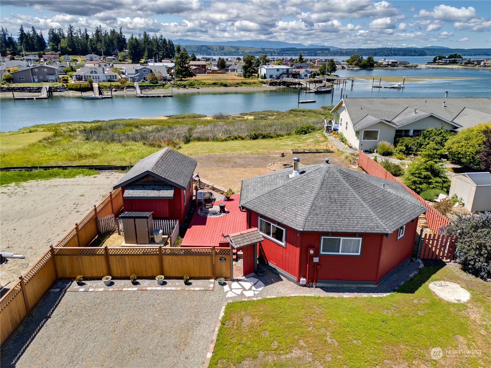 an aerial view of a house with swimming pool and a yard