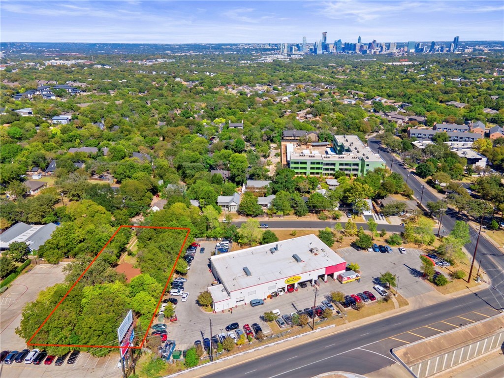 an aerial view of residential houses with outdoor space and street view