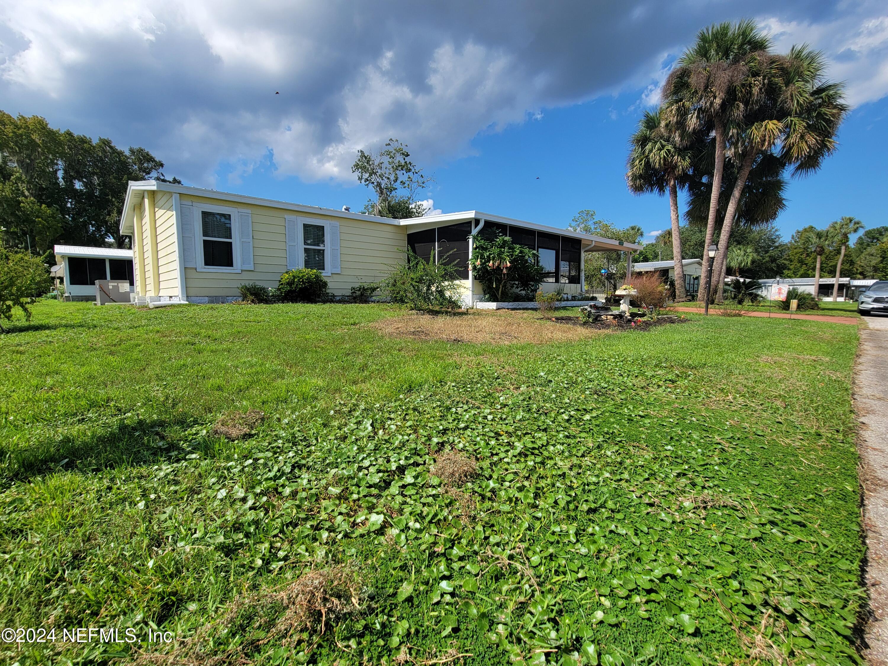 a view of a house with a back yard