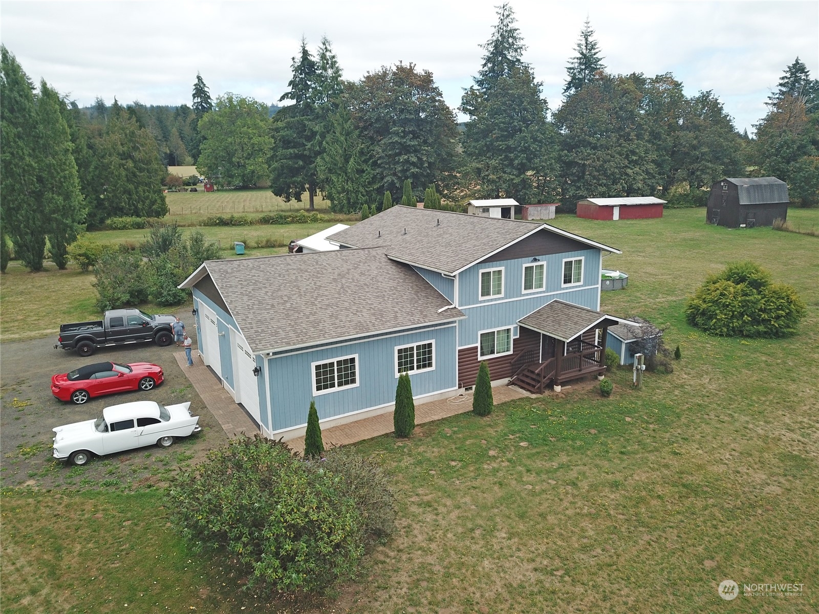 a aerial view of a house with swimming pool and a yard