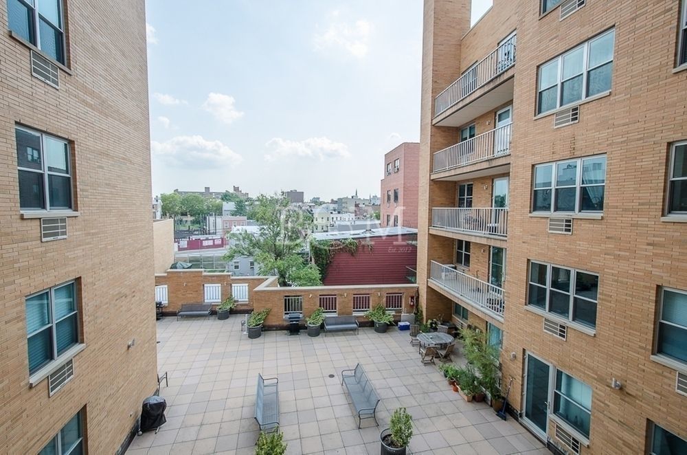 a view of roof deck with patio