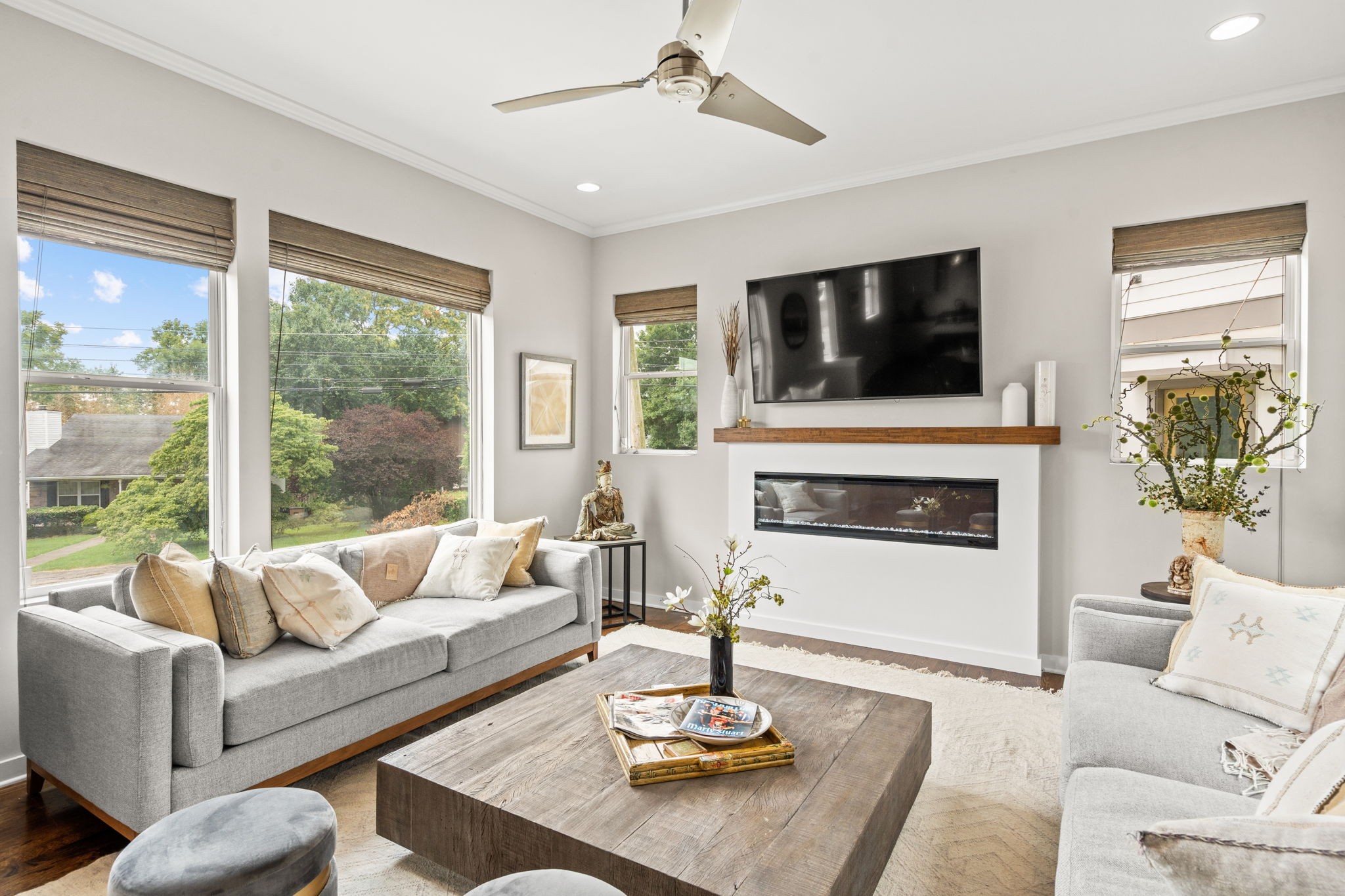 a living room with furniture a fireplace and a flat screen tv