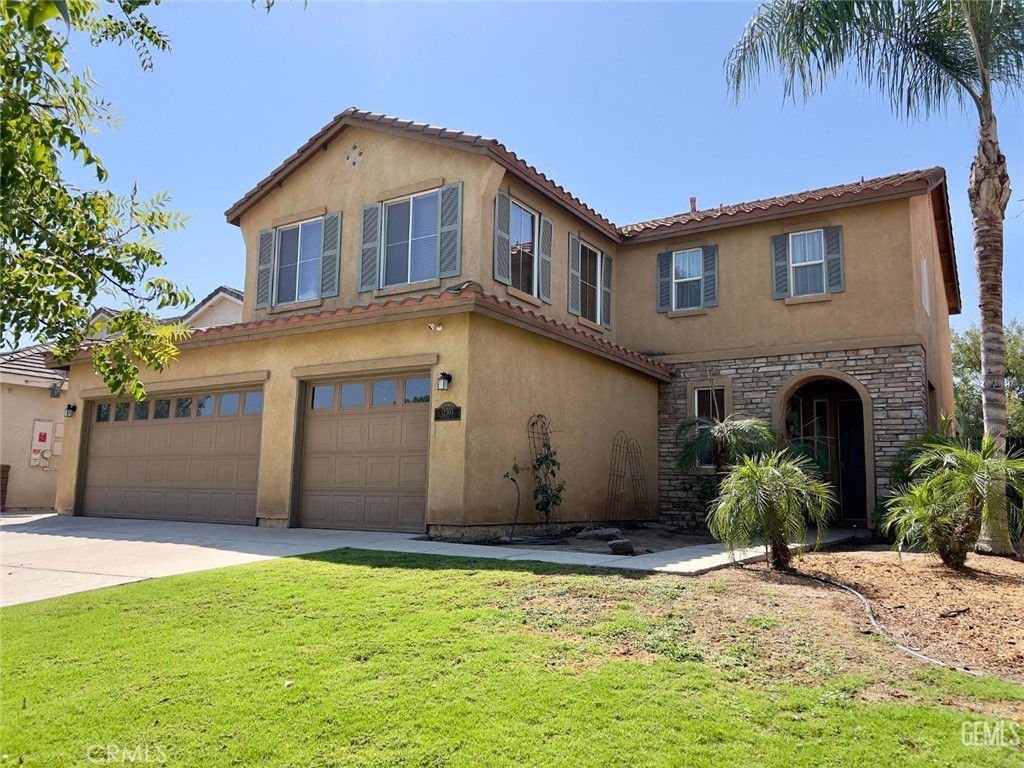 a front view of a house with a yard and garage