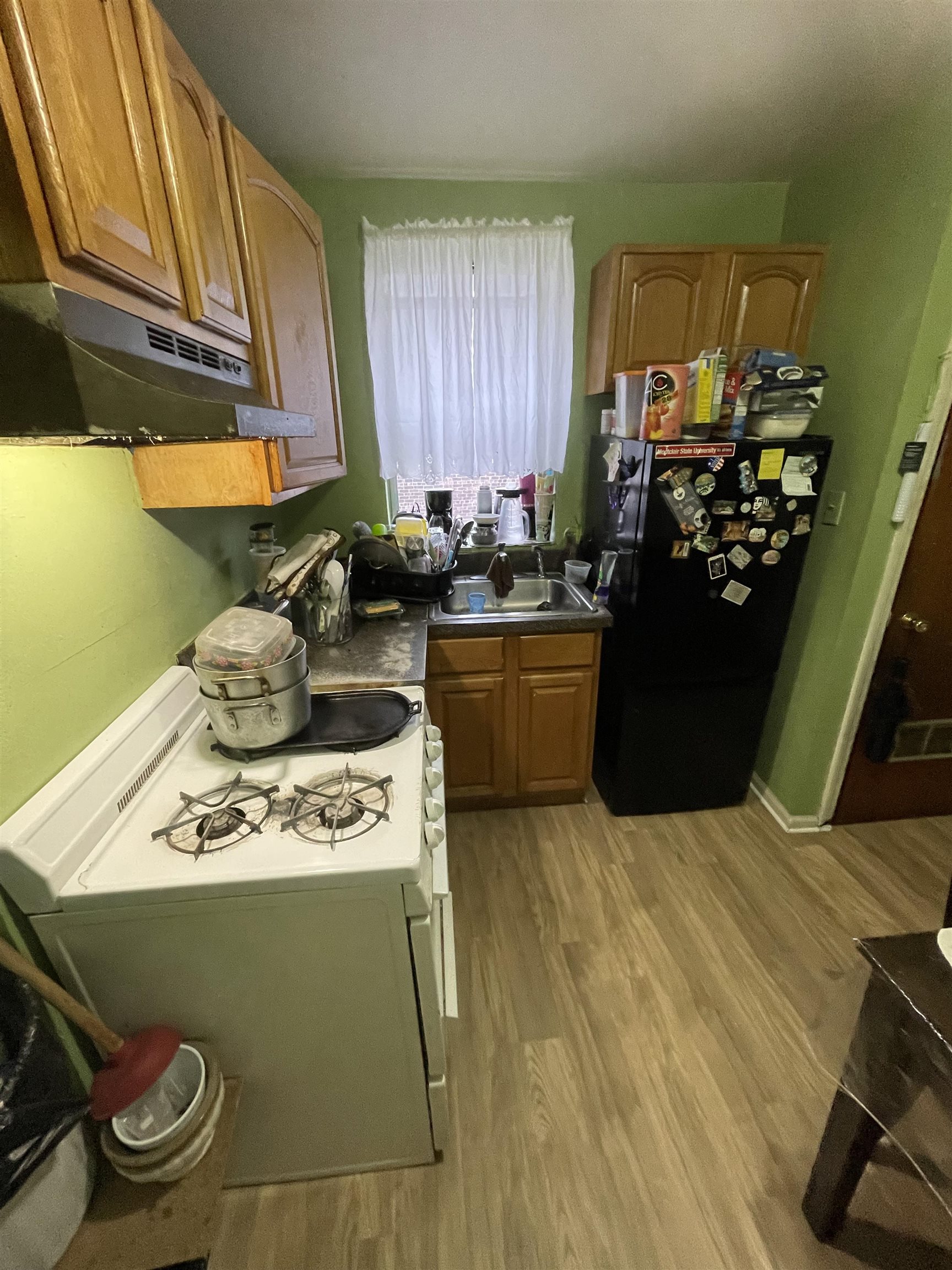 a kitchen with a sink appliances and cabinets