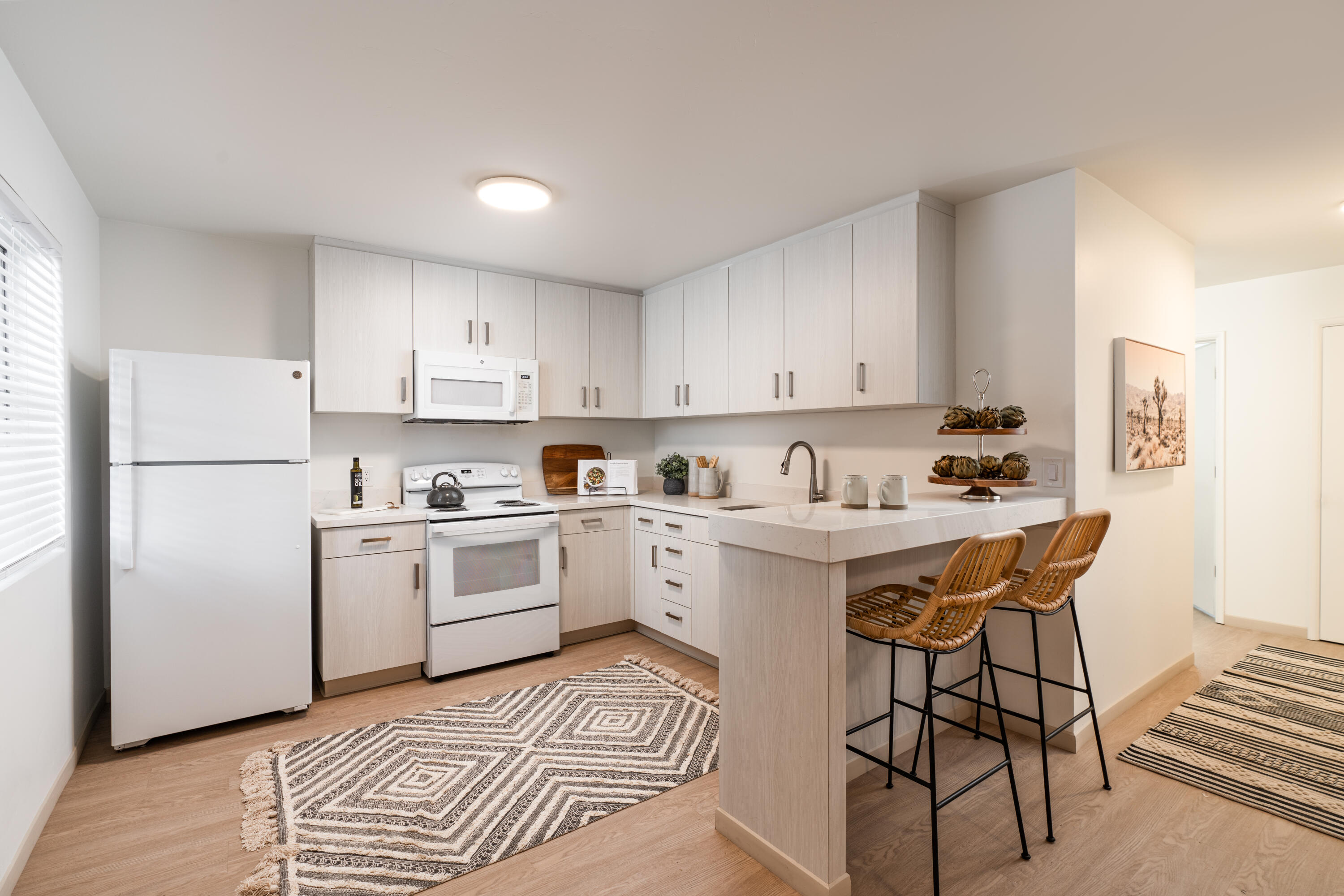 a kitchen with a white stove top oven and white refrigerator