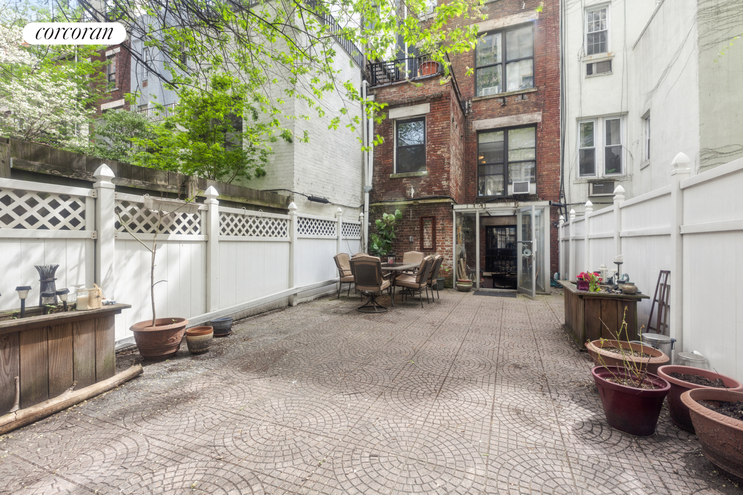 a view of a patio with table and chairs and potted plants