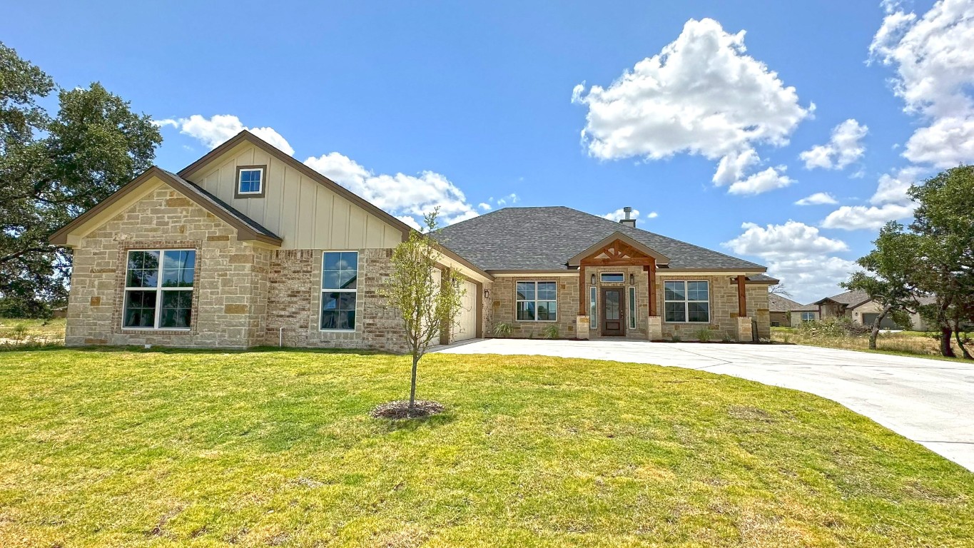 a front view of a house with a yard