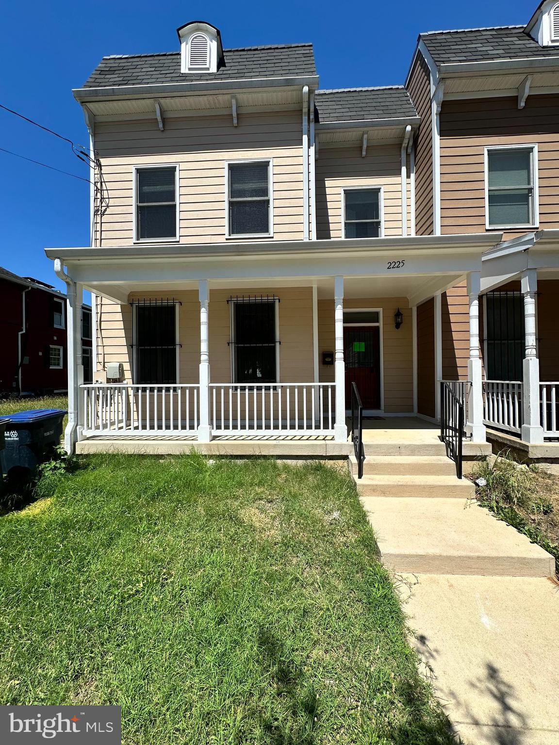 a view of a house with yard and porch