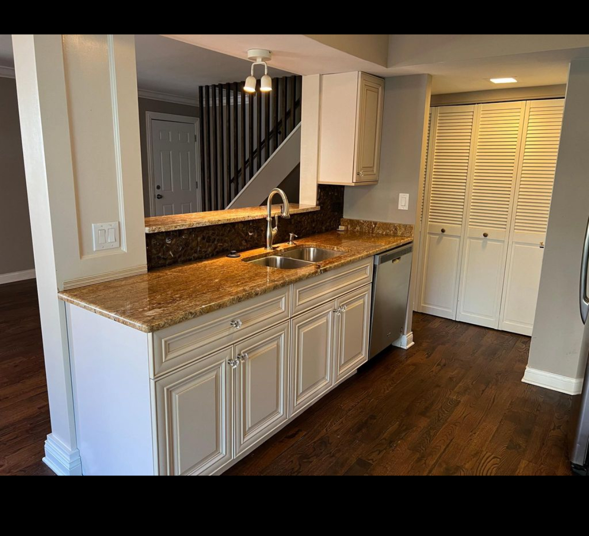 a kitchen with a sink and cabinets