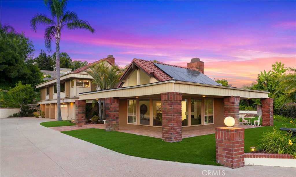 a front view of a house with a garden and yard