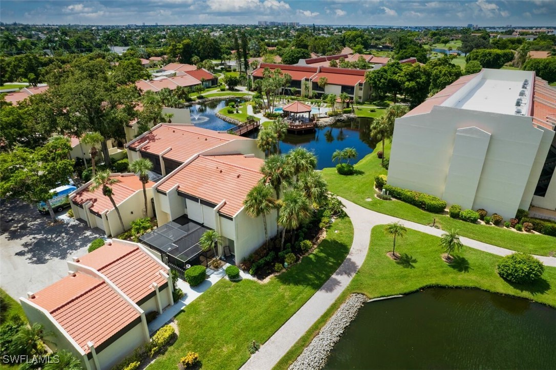 an aerial view of a house with a garden and lake view