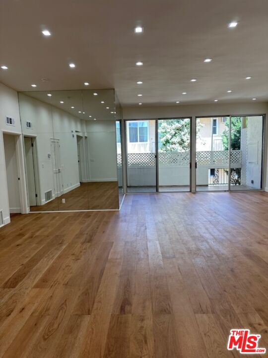 a view of a hall with wooden floor