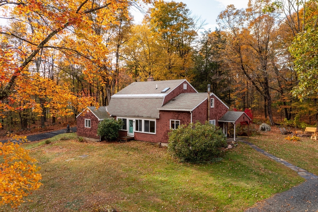 a house that has a tree in front of it