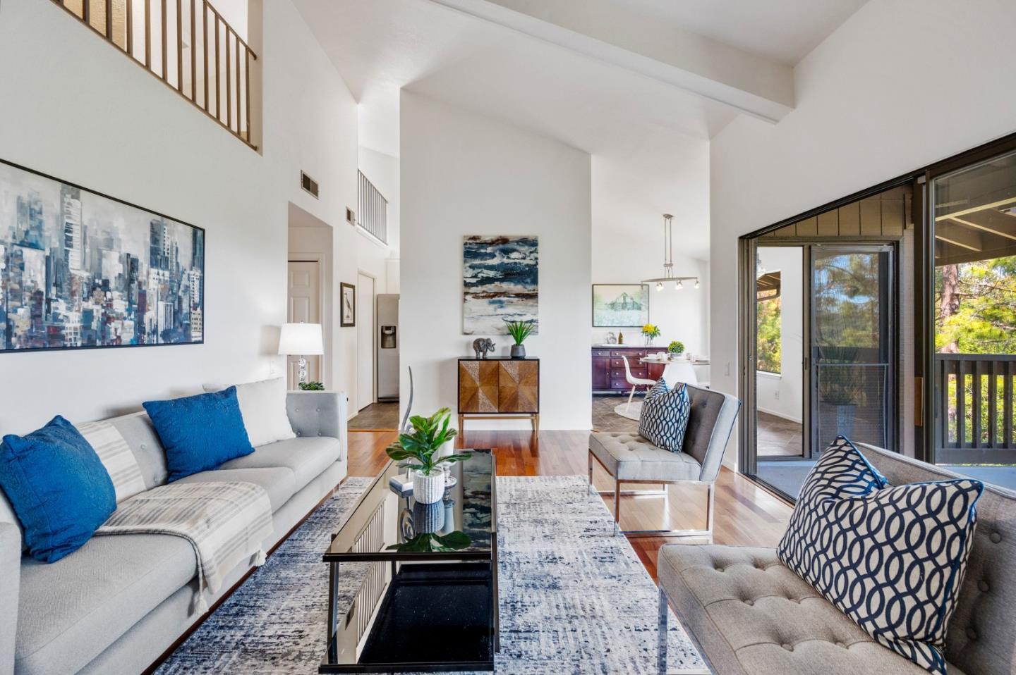 a living room with furniture and a floor to ceiling window