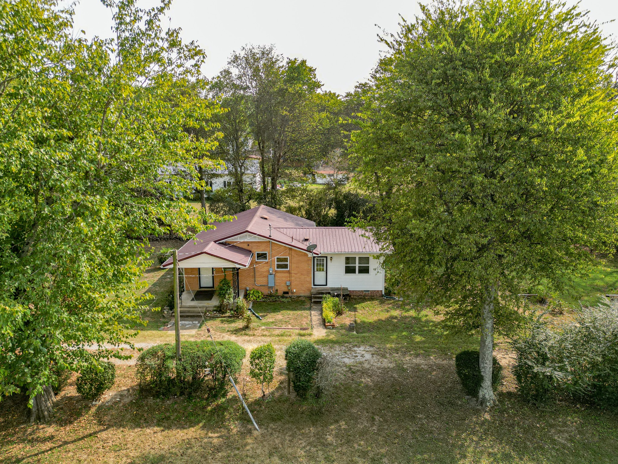 a aerial view of a house with a yard table and chairs