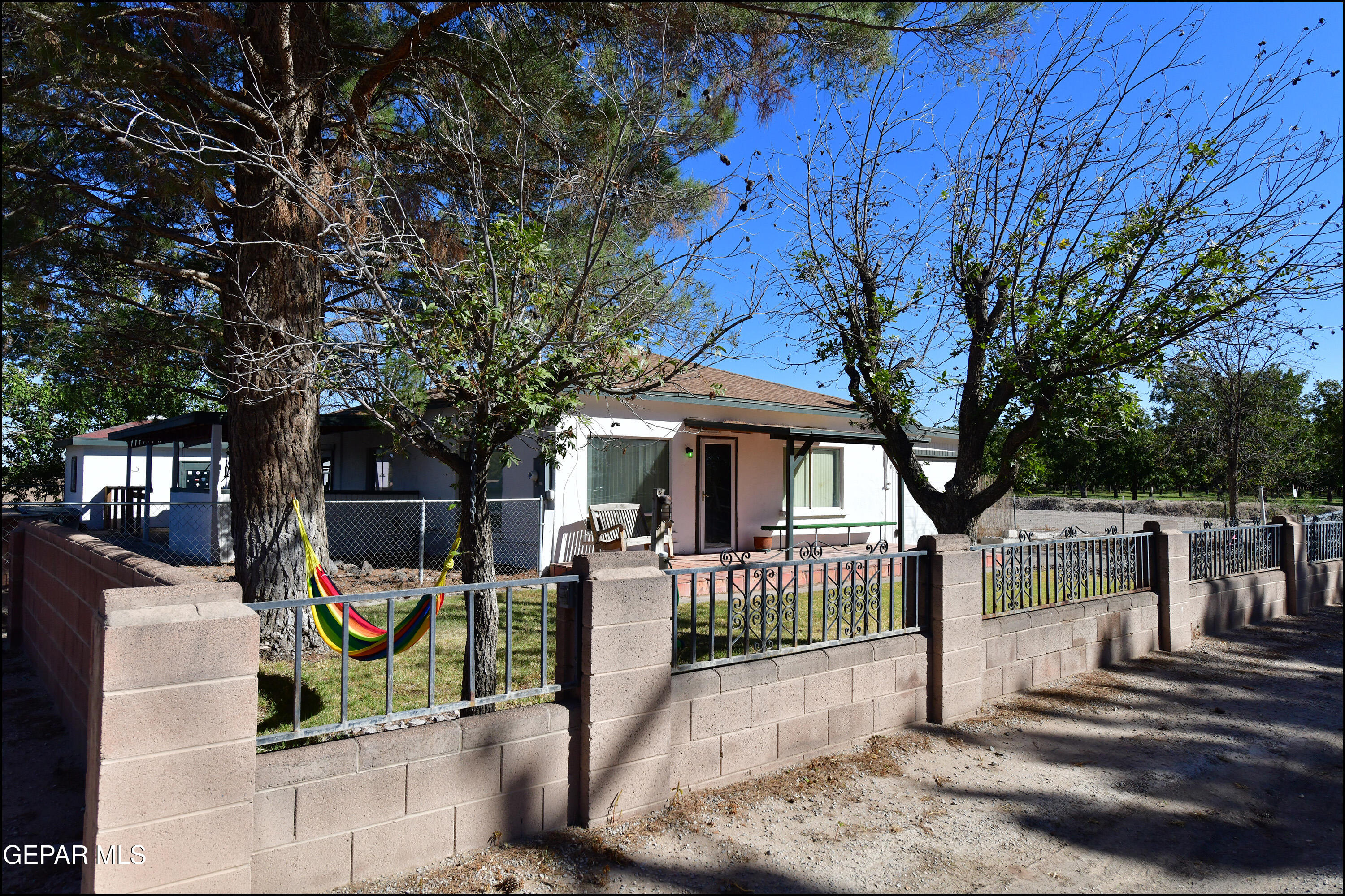 a view of a park with iron fence