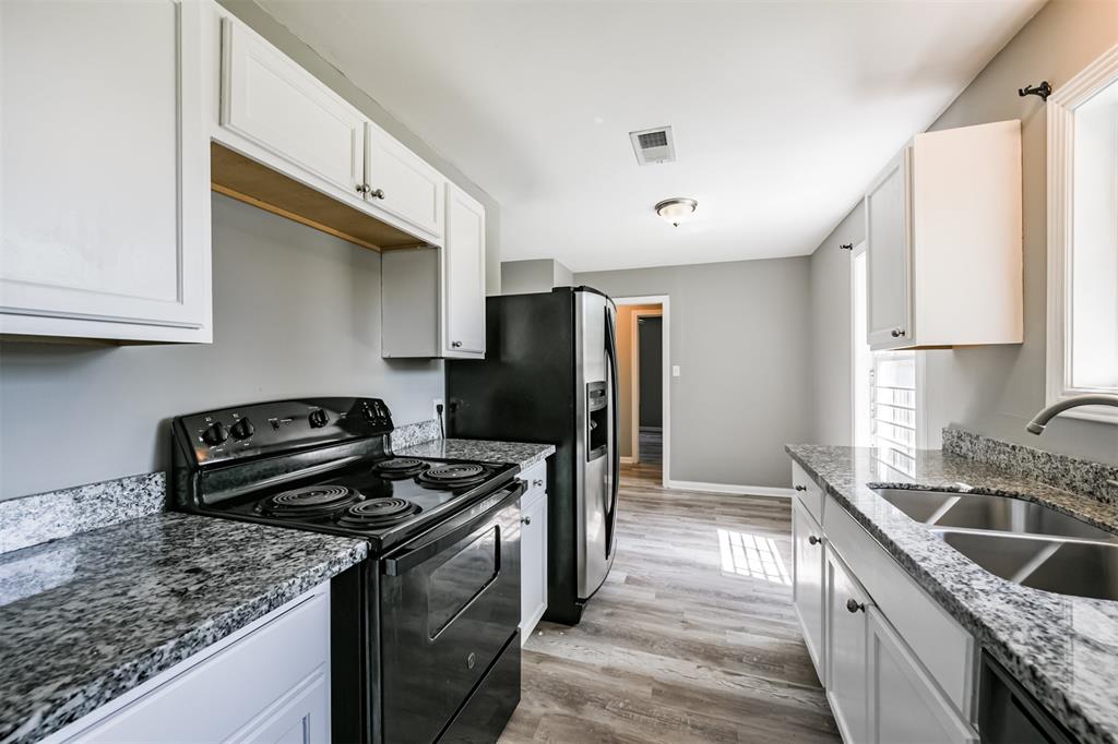 a kitchen with a sink stove and refrigerator