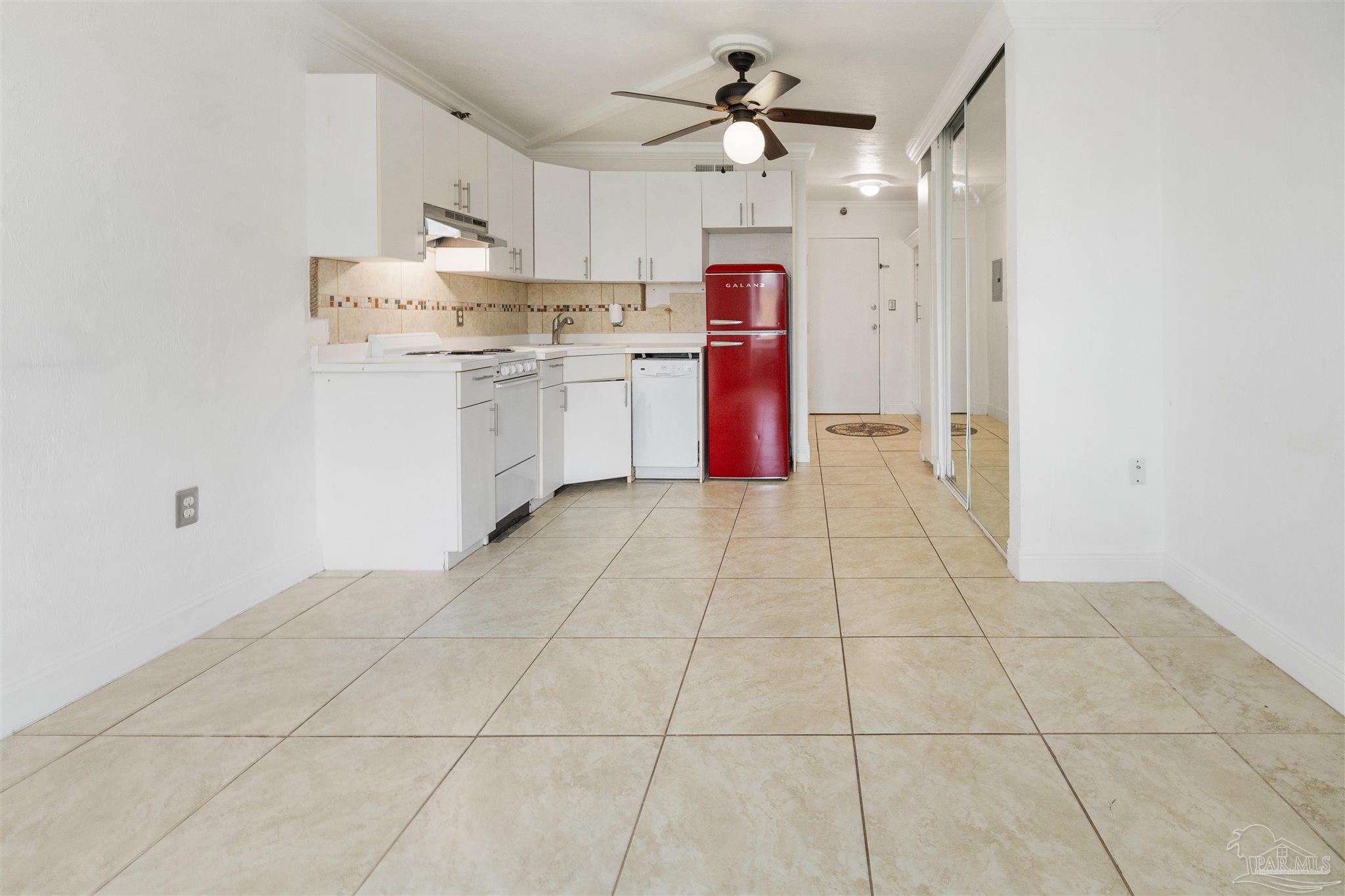 a large kitchen with cabinets and stainless steel appliances