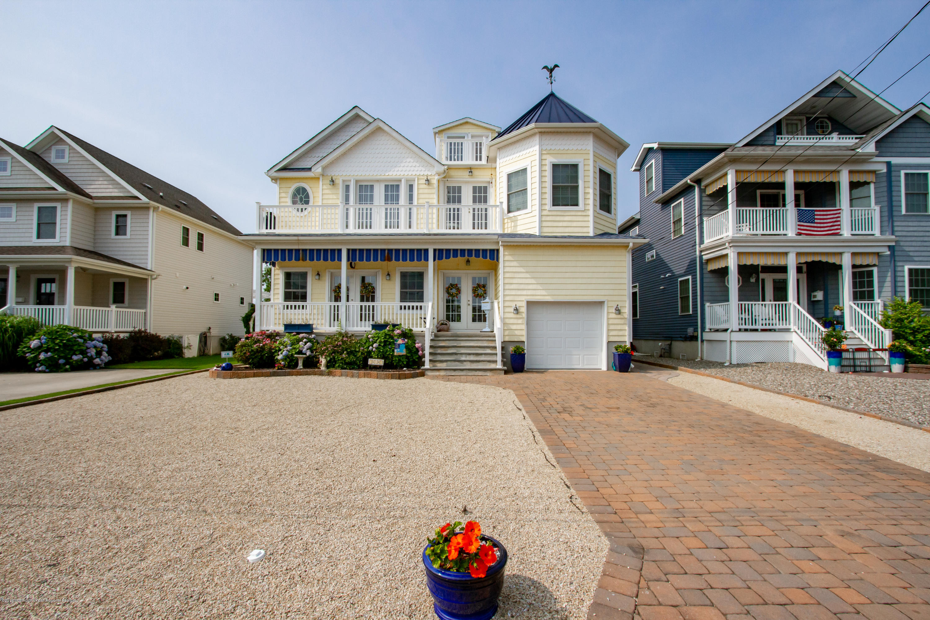 a front view of a house with a yard and a garage