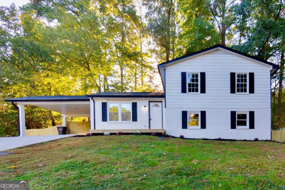 a front view of house with yard and green space