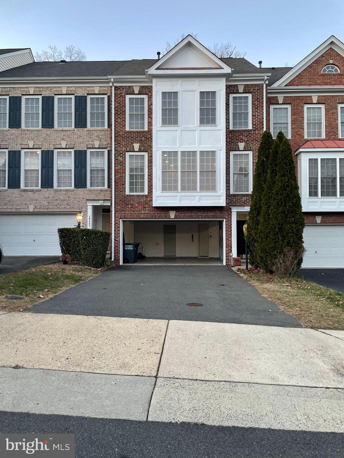 a front view of a building with a yard and a garage